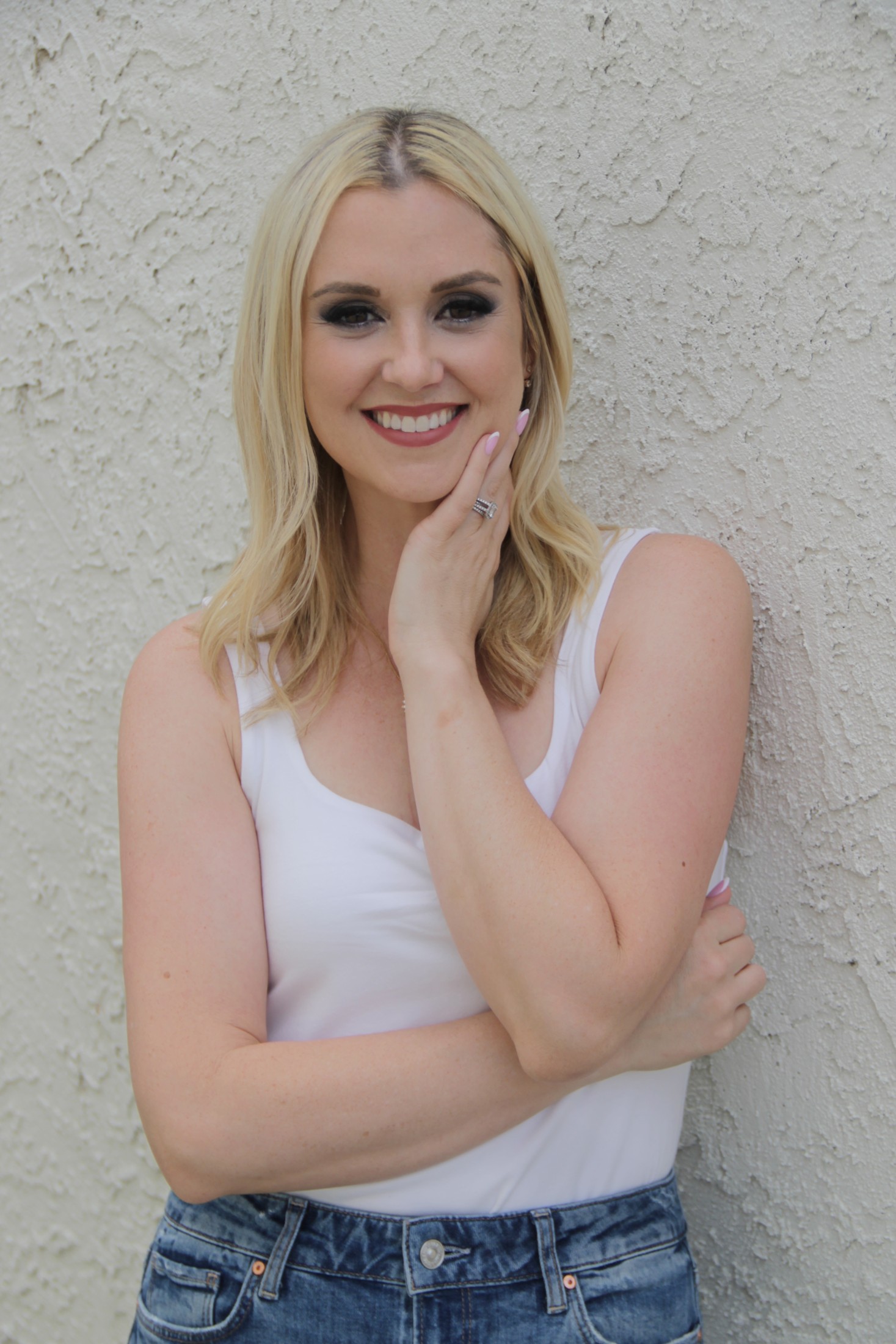 Jenna Barnett in a white top and jeans